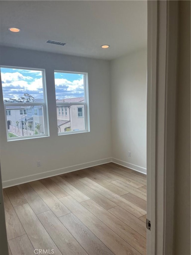 unfurnished room featuring recessed lighting, visible vents, baseboards, and light wood-style floors