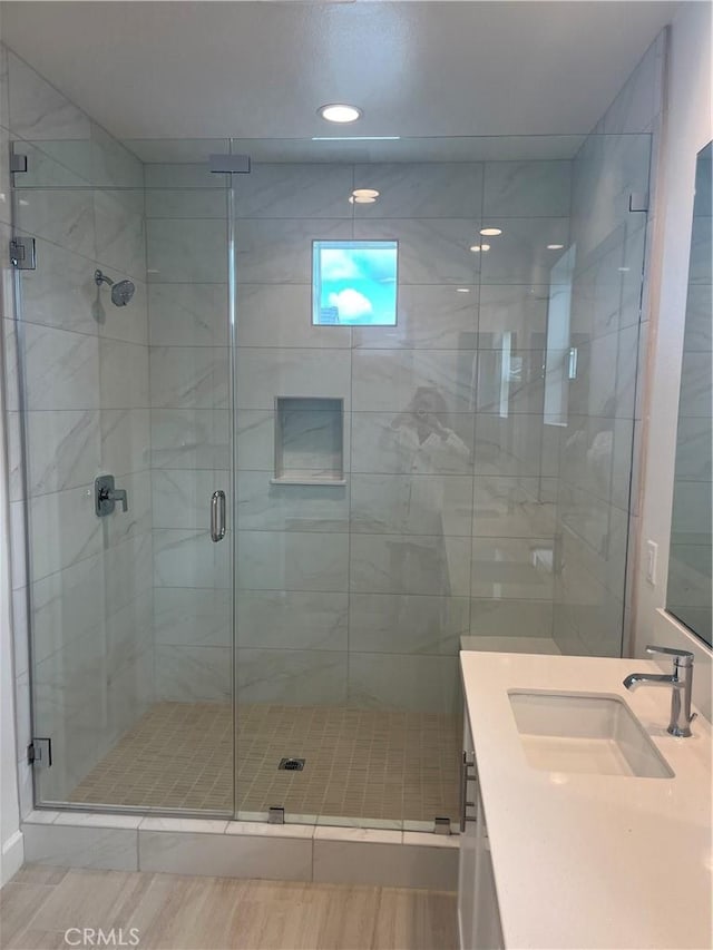 full bathroom with vanity, a shower stall, and recessed lighting
