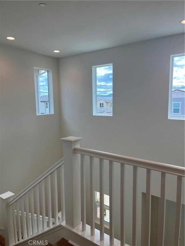 staircase featuring recessed lighting
