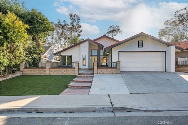 mid-century inspired home with a front yard, fence, concrete driveway, an attached garage, and stucco siding