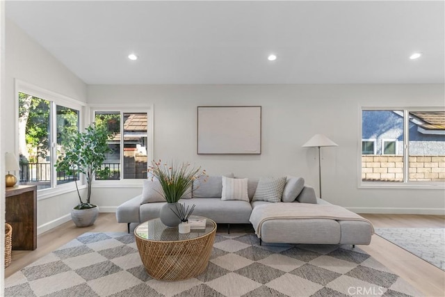 living room with recessed lighting, plenty of natural light, and wood finished floors