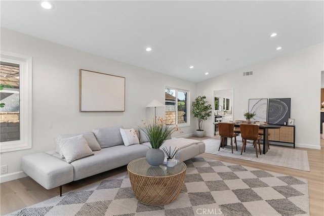 living area with baseboards, recessed lighting, and wood finished floors