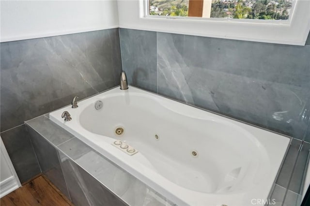 28846 Yosemite Pl, Canyon Lake, CA 92587 - bathroom featuring a tub with jets and wood finished floors
