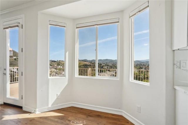 28846 Yosemite Pl, Canyon Lake, CA 92587 - empty room featuring wood finished floors, plenty of natural light, and a mountain view