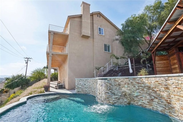 28846 Yosemite Pl, Canyon Lake, CA 92587 - back of property featuring stucco siding, a balcony, and a chimney
