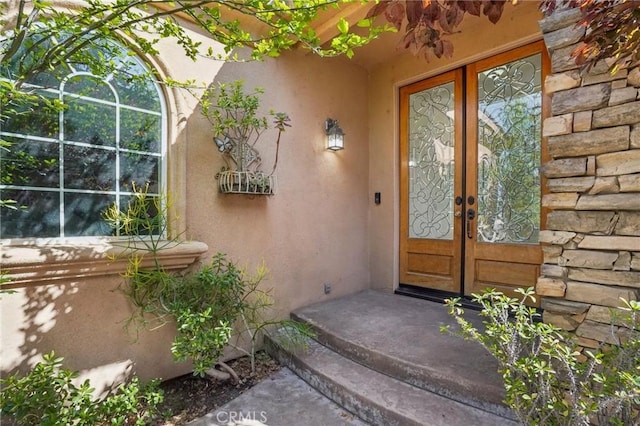 28846 Yosemite Pl, Canyon Lake, CA 92587 - view of exterior entry with french doors, stucco siding, and stone siding