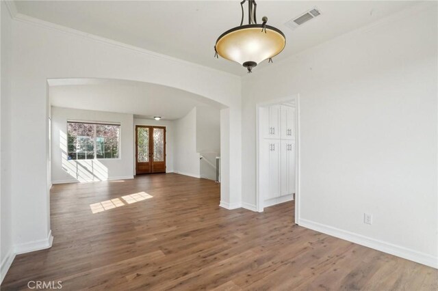 28846 Yosemite Pl, Canyon Lake, CA 92587 - spare room with arched walkways, wood finished floors, french doors, and crown molding