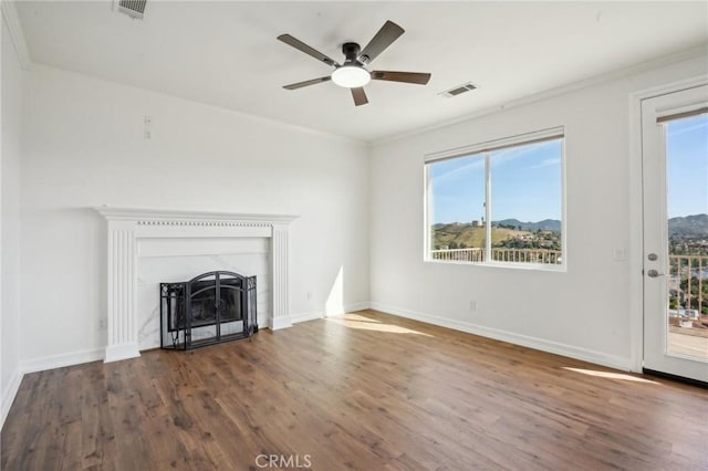 28846 Yosemite Pl, Canyon Lake, CA 92587 - unfurnished living room featuring plenty of natural light, wood finished floors, ceiling fan, and ornamental molding