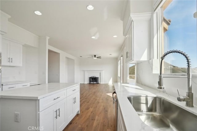 28846 Yosemite Pl, Canyon Lake, CA 92587 - kitchen featuring a ceiling fan, white cabinets, a center island, recessed lighting, and a fireplace