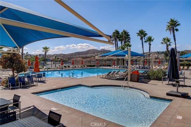 28846 Yosemite Pl, Canyon Lake, CA 92587 - community pool featuring a mountain view and a patio area