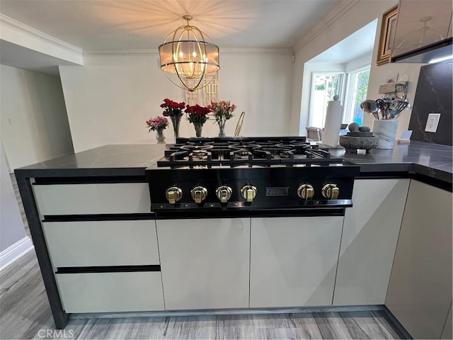interior space with dark countertops, ornamental molding, and light wood finished floors