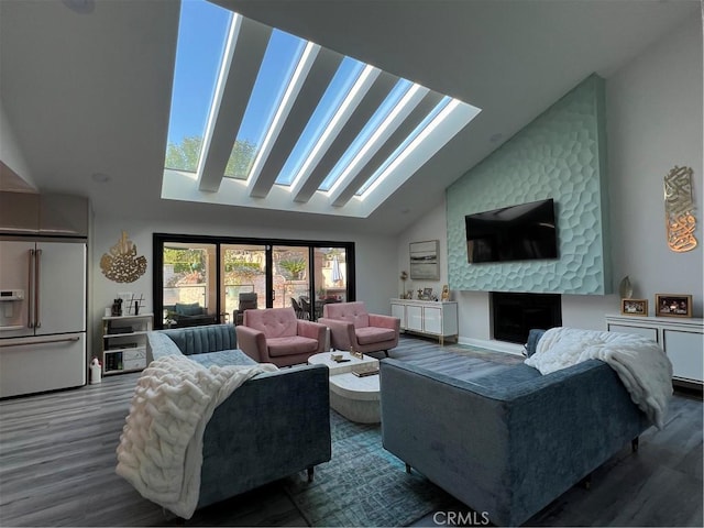 living area featuring high vaulted ceiling, a skylight, wood finished floors, and a fireplace