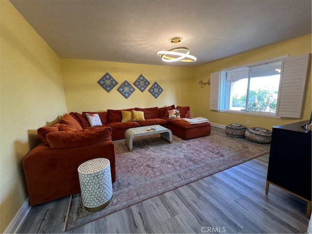 living area featuring baseboards and wood finished floors