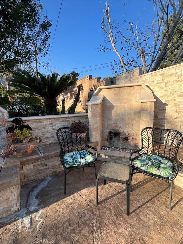 view of patio with an outdoor stone fireplace
