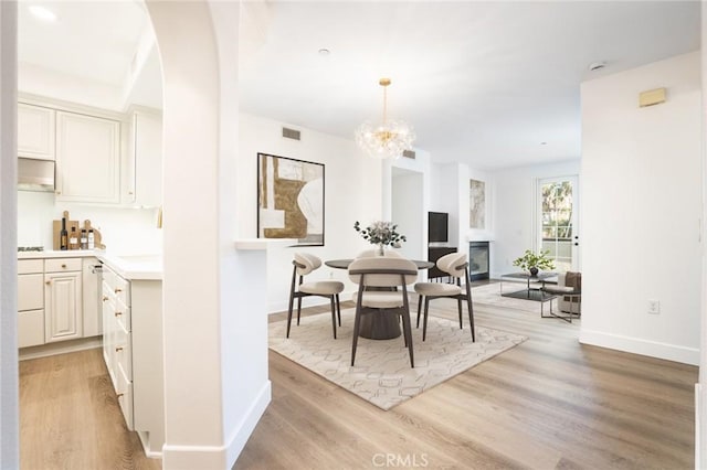 5935 Playa Vista Dr Unit 307, Playa Vista, CA 90094 - dining room with a notable chandelier, visible vents, baseboards, and light wood finished floors