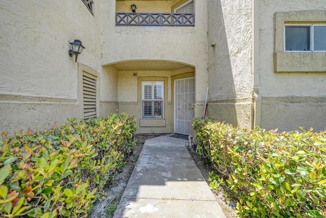 doorway to property with stucco siding
