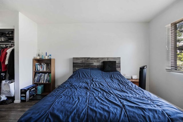 bedroom featuring baseboards and wood finished floors