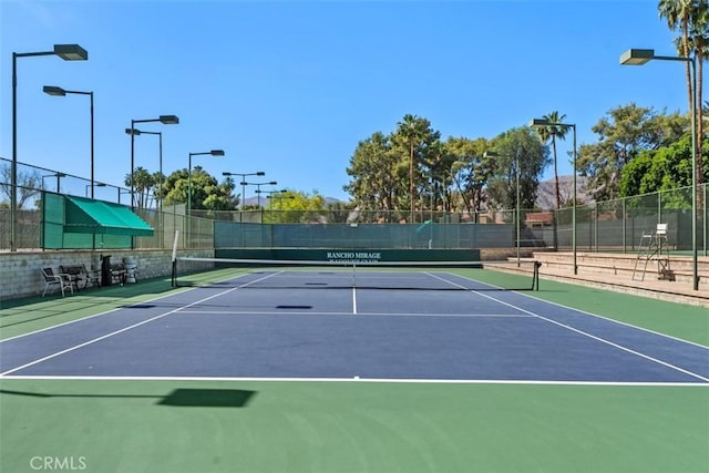 74 Tennis Club Dr, Rancho Mirage, CA 92270 - view of tennis court featuring fence and community basketball court