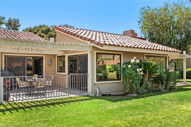 74 Tennis Club Dr, Rancho Mirage, CA 92270 - rear view of house with a pergola, stucco siding, a chimney, a tiled roof, and a lawn