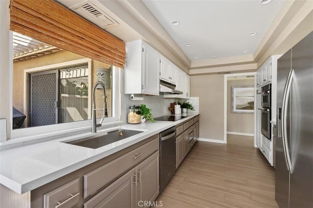 74 Tennis Club Dr, Rancho Mirage, CA 92270 - kitchen featuring visible vents, light countertops, under cabinet range hood, a sink, and appliances with stainless steel finishes