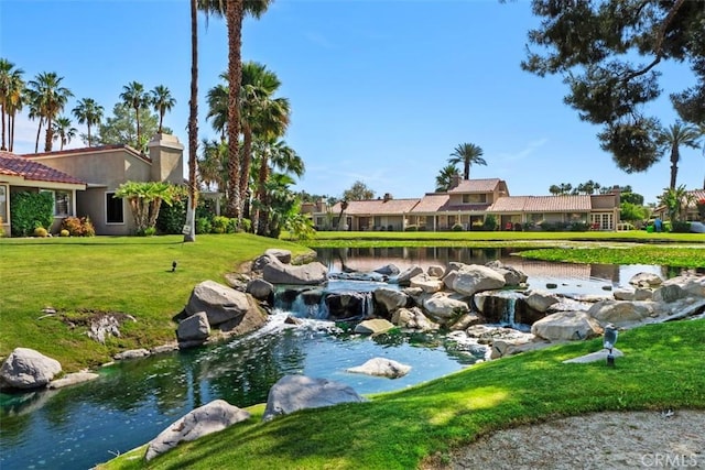 74 Tennis Club Dr, Rancho Mirage, CA 92270 - view of home's community with a lawn and a garden pond