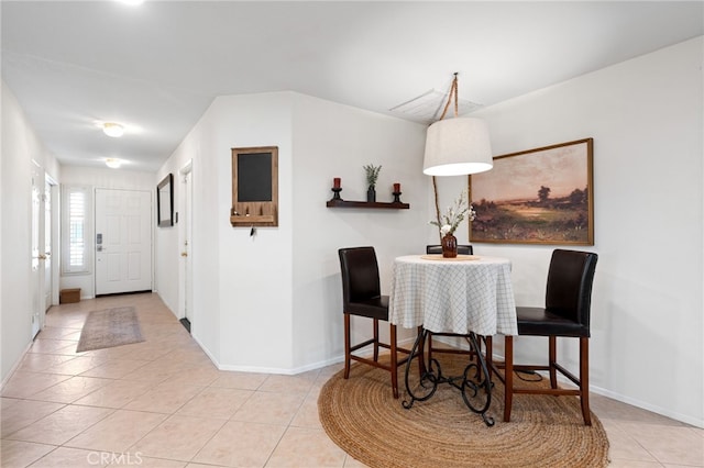 dining room with tile patterned flooring and baseboards
