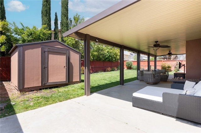 view of patio / terrace with an outdoor hangout area, a storage shed, a fenced backyard, a ceiling fan, and an outdoor structure