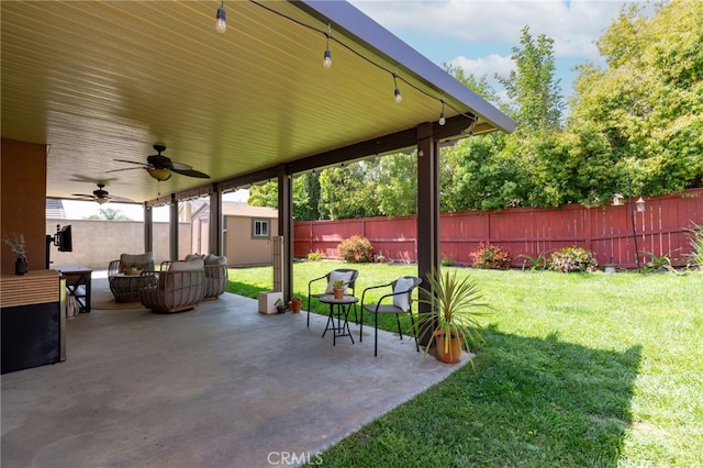 view of patio with an outdoor structure, a fenced backyard, a shed, an outdoor living space, and a ceiling fan