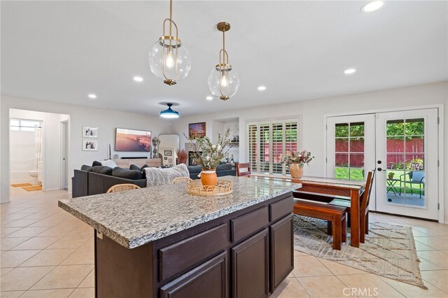 kitchen with light tile patterned floors, dark brown cabinetry, and recessed lighting