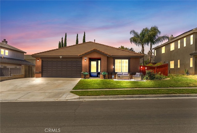 ranch-style home featuring an attached garage, stucco siding, a tile roof, and concrete driveway