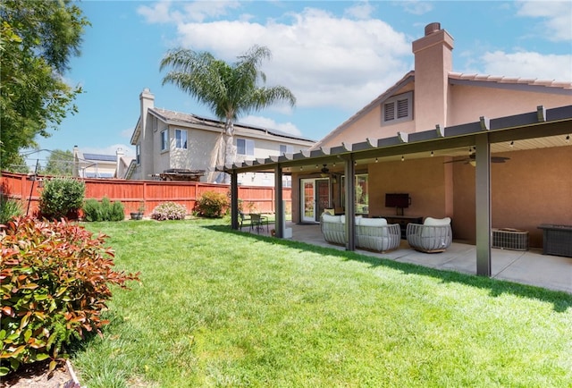 view of yard with fence, ceiling fan, a patio area, and outdoor lounge area