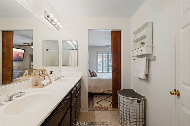 bathroom with a sink, connected bathroom, a ceiling fan, and tile patterned floors