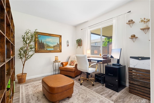 office space featuring baseboards and wood finished floors