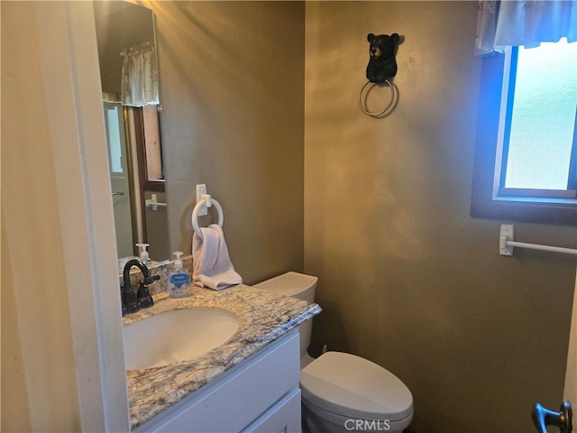 bathroom with toilet and vanity