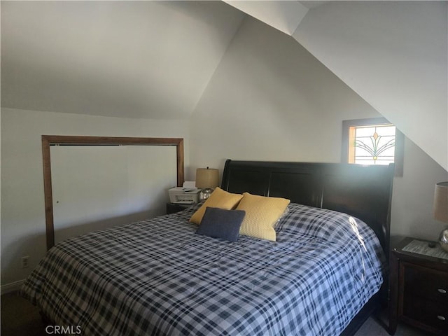 bedroom with carpet floors and vaulted ceiling