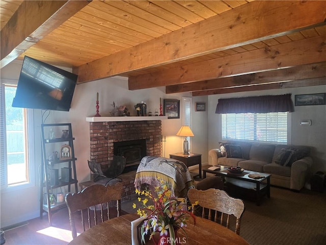 living room featuring beam ceiling, baseboards, and wood ceiling