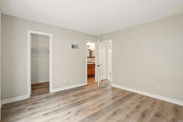 4230 48th St Unit 5, San Diego, CA 92115 - unfurnished bedroom featuring a spacious closet, a closet, light wood-type flooring, baseboards, and visible vents