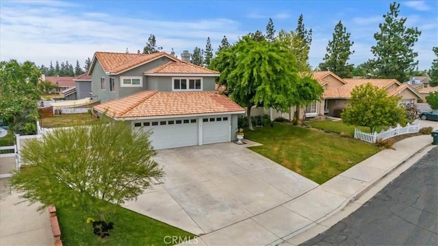 view of front of house with driveway, a tiled roof, stucco siding, fence, and a front lawn