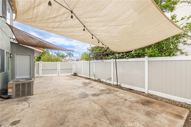 view of patio with a gate, central AC, and a fenced backyard