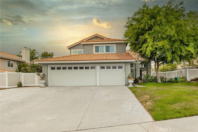 traditional home with fence, stucco siding, concrete driveway, and a lawn