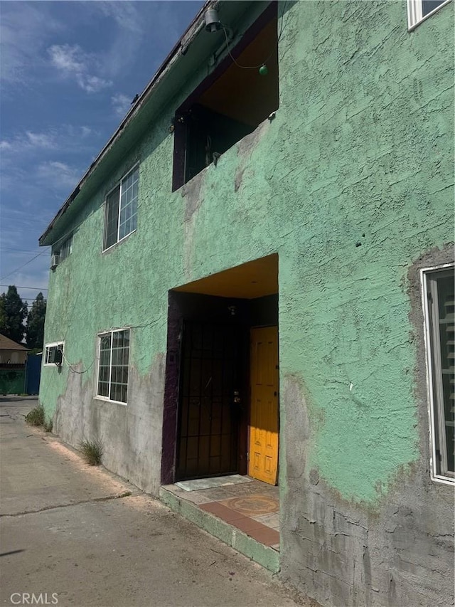 entrance to property featuring stucco siding