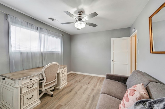 office featuring visible vents, ceiling fan, light wood finished floors, and baseboards