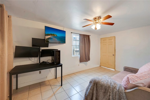 interior space featuring a ceiling fan, tile patterned flooring, and baseboards