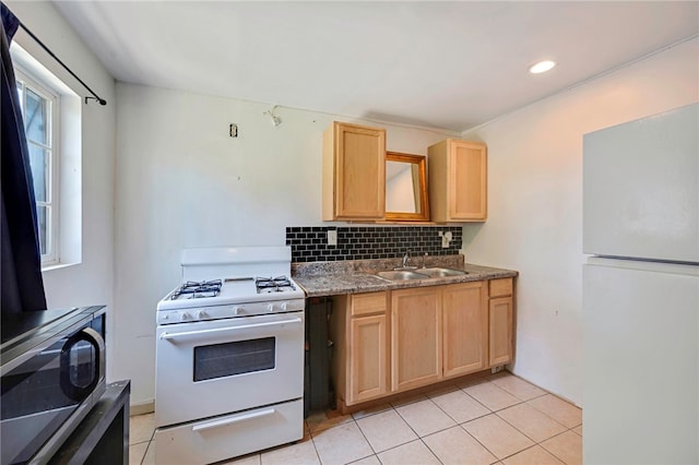kitchen with white appliances, decorative backsplash, light brown cabinetry, light tile patterned floors, and a sink