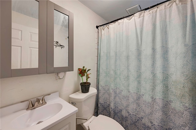bathroom featuring toilet, visible vents, vanity, and a shower with shower curtain