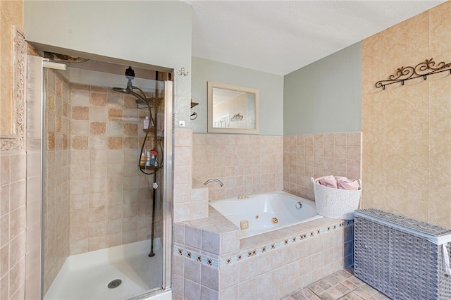 full bathroom featuring a tub with jets and a stall shower