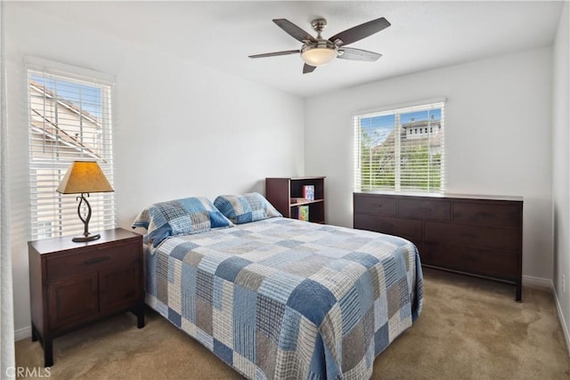 bedroom with baseboards, light carpet, and a ceiling fan