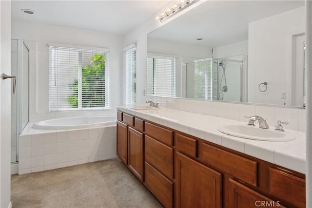 full bathroom with double vanity, a sink, a bath, and a stall shower
