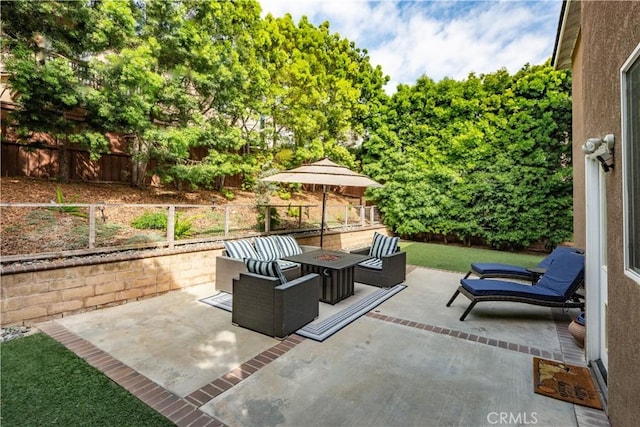 view of patio / terrace featuring fence and an outdoor fire pit