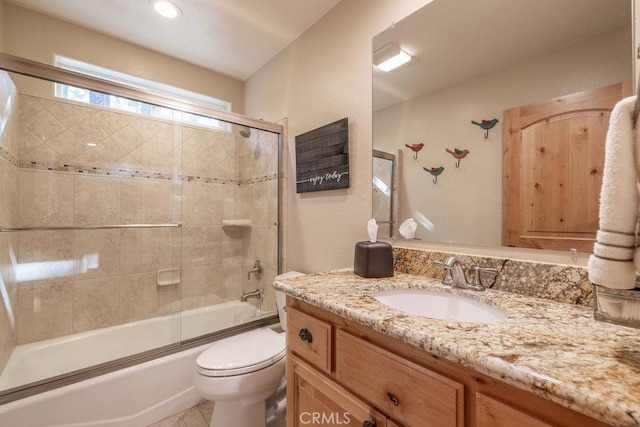 full bathroom with toilet, enclosed tub / shower combo, and vanity